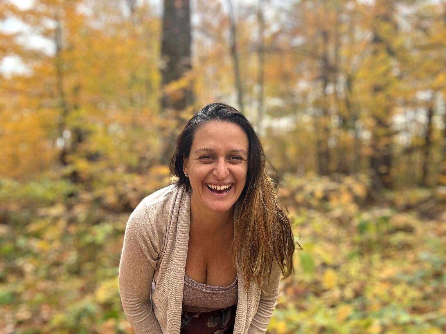 Tanya Fendrikov laughing in the autumn woods